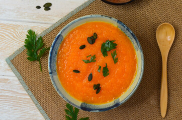 Autumn delicious food, hearty pumpkin soup top view, healthy nutrition on autumn dinner, the...