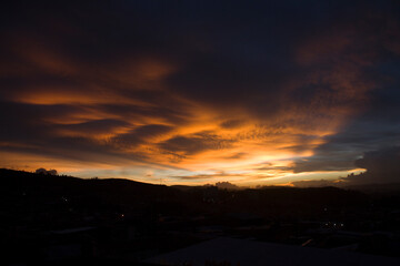 orange sunset with lots of clouds in the sky
