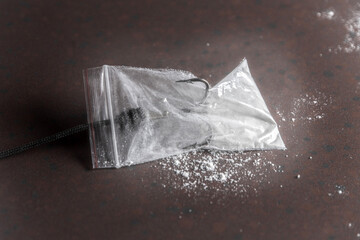 drug trap concept: drug bag with triple hook inside