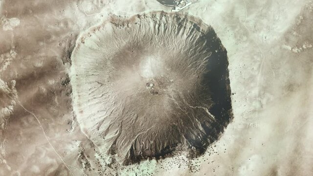 Meteor Crater, also known as Barringer Crater, in the northern Arizona desert of the United States, Seen from Space. Elements of this video furnished by NASA. 