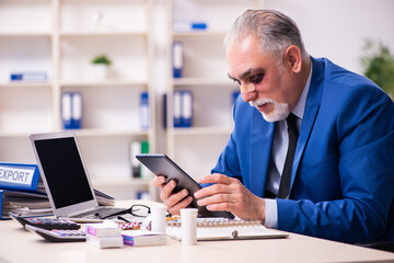 Old face injured employee sitting in the office