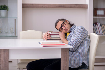 Young male student preparing for exam at home