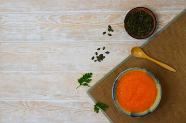 Autumn delicious food, hearty pumpkin soup top view, healthy nutrition on autumn dinner, the concept of thanksgiving day