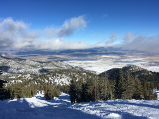 Fototapeta na wymiar Landscape view of Carson valley and the slopes of a ski resort in tahoe on a sunny winter day with clouds