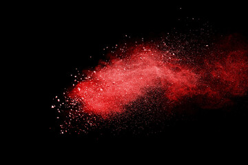Red powder explosion on black background. Paint Holi.