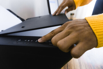 Closeup of a person using a scanner on the desk at home