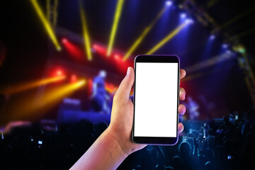 Hand with a smartphone records live music concert festival