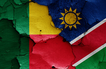 flags of Benin and Namibia painted on cracked wall