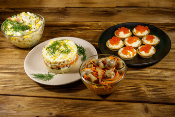 Set of various festive dishes on a wooden table