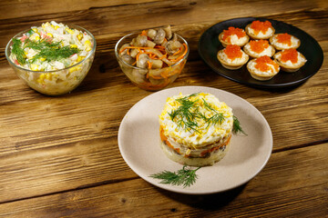 Set of various festive dishes on a wooden table