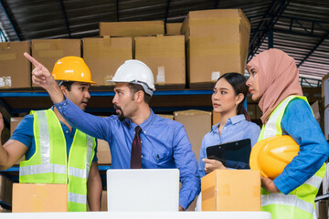 Group of Diversity warehouse worker meeting and brainstorming together in local warehouse, muslim with Hijab, indian, white caucasian and asian people wearing safety clothes in export industry concept