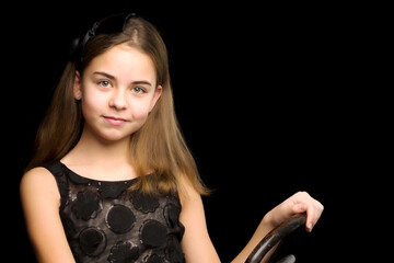 Fototapeta premium Close-up.Portrait of a cute little girl on a black background.