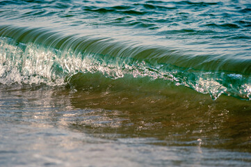 Small waves rolling onto a sandy beach