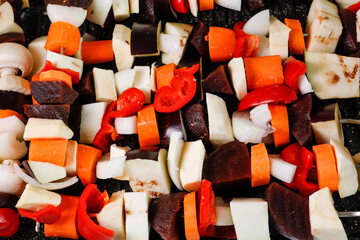 Raw vegetable skewers ready to be grilled on an oven tray