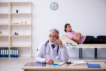 Young male patient visiting old male doctor