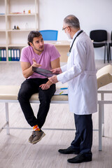 Fototapeta premium Old doctor radiologist examining young male patient