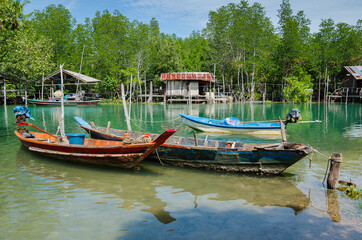 Naklejka na ściany i meble The Fisherman's Boats is Moored on the Clear Water at Southern Province of Thailand.