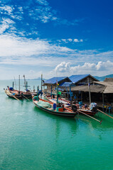 Fototapeta na wymiar The Fisherman Village On the Clear Sea Water in Southern Thailand.