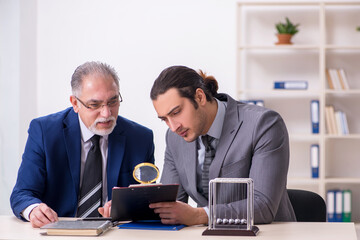 Two businessmen and meditation balls on the table