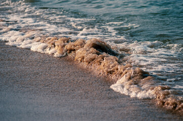 Small waves rolling onto a sandy beach