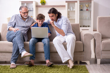 Boy and his father and his grandfother indoor