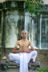 indian priest child doing yoga at park