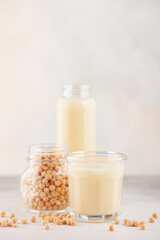 Vegetable pea milk in a bottle and peas in a jar. Gluten free, lactose free product