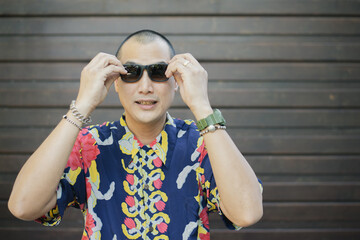 Lifestyle series: Skinhead Asian man putting sunglasses on