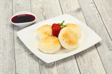 Curd pancakes with jam and stravberry
