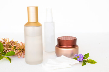 the therapy first serum toners, eyes cream, water callagen spray and  cotton natural cosmetics extract herbal health care for skin face beauty of woman  arrangement flat lay style on white