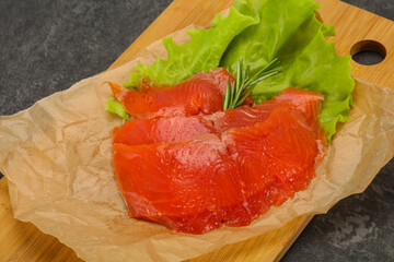 Sliced salmon fillet served rosemary