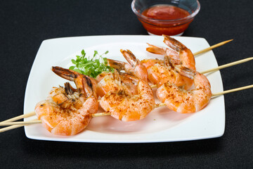 Grilled prawn skewer with sauce