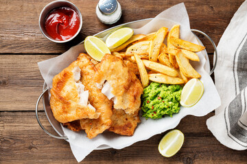 British Traditional Fish and chips with mashed peas and sauce. - 379064586