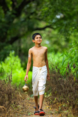 a priest child walking at forest