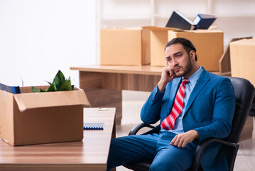 Young male employee in relocation concept