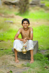 A indian priest child with holy water pot