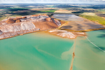 Mountains of products for the production of potash salt and artificial turquoise reservoirs.Salt mountains near the city of Soligorsk.Production of fertilizers for the Land. Belarus