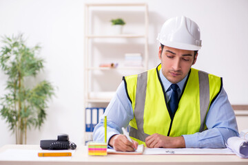 Young male architect working in the office