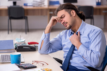 Sick male employee suffering at workplace