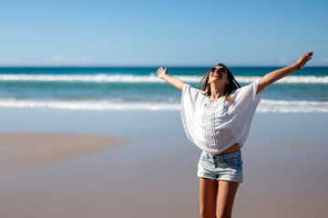 Young woman spinning on the beach