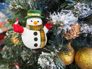 A snowman hanging on a christmas tree