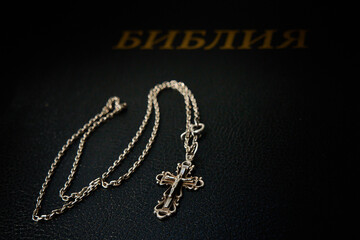 Fototapeta na wymiar Cross with chain on the bible.