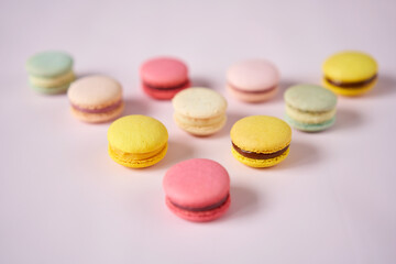 French cake macaron. Set of cute sweets on pastel pink background. almond cookies, pastel colors, top view