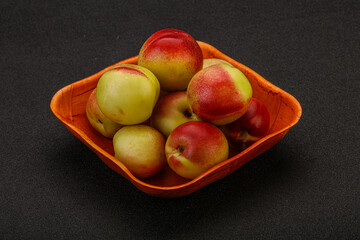 Sweet small nectarines in the basket