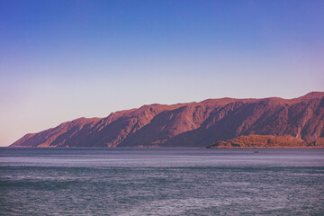 Seascape during sunset. Rocky seashore in the evening. Beautiful nature, wilderness.