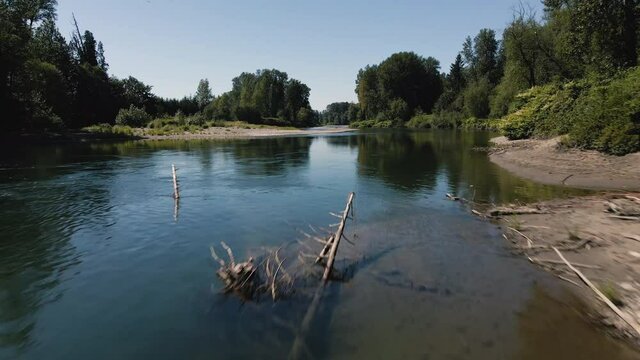 Fast Drone Flying Low Over River Water Surface with Vibrant Natural Environment Colors
