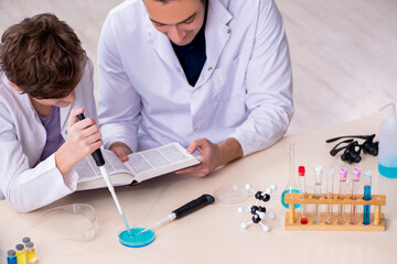 Young father and son chemists in the lab