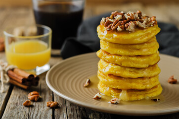Pumpkin pancakes with pecans in a plate