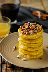 Pumpkin pancakes with pecans in a plate