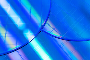 Macro of blue silicon wafer with microchips.